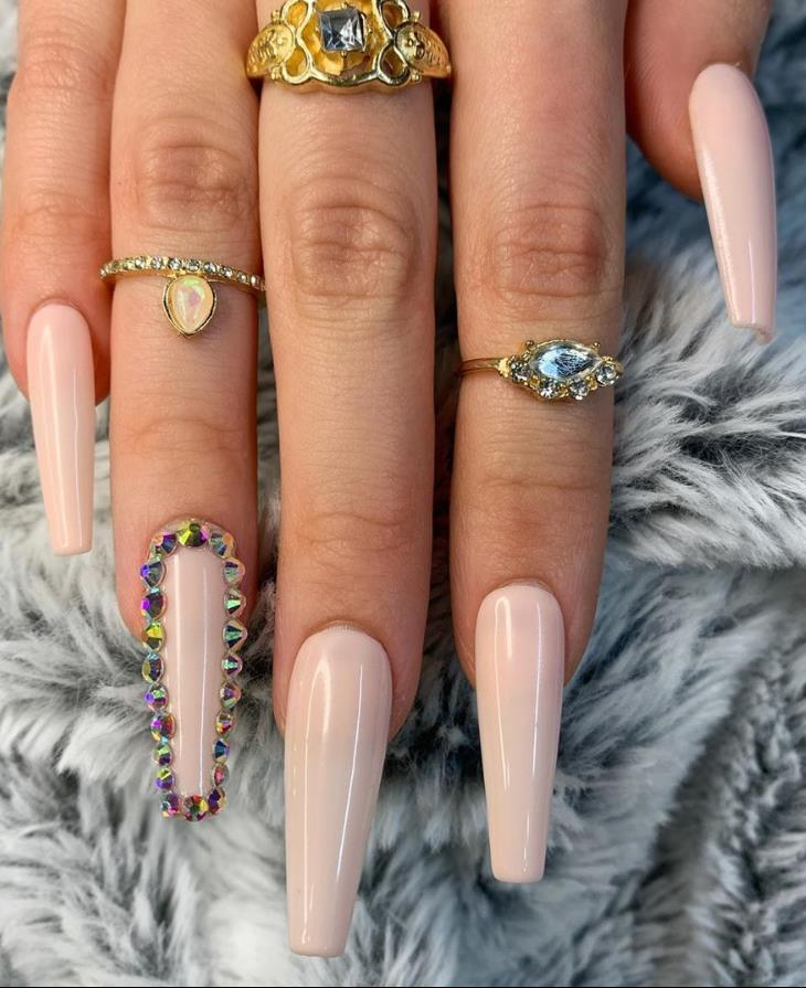 White half moons adorned with gemstones on each nail 