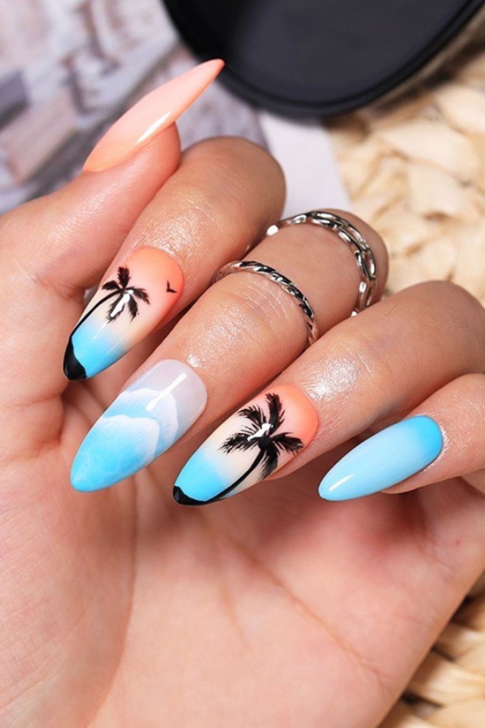 Almond beach nail design with blue sky, white clouds and coconut palm trees