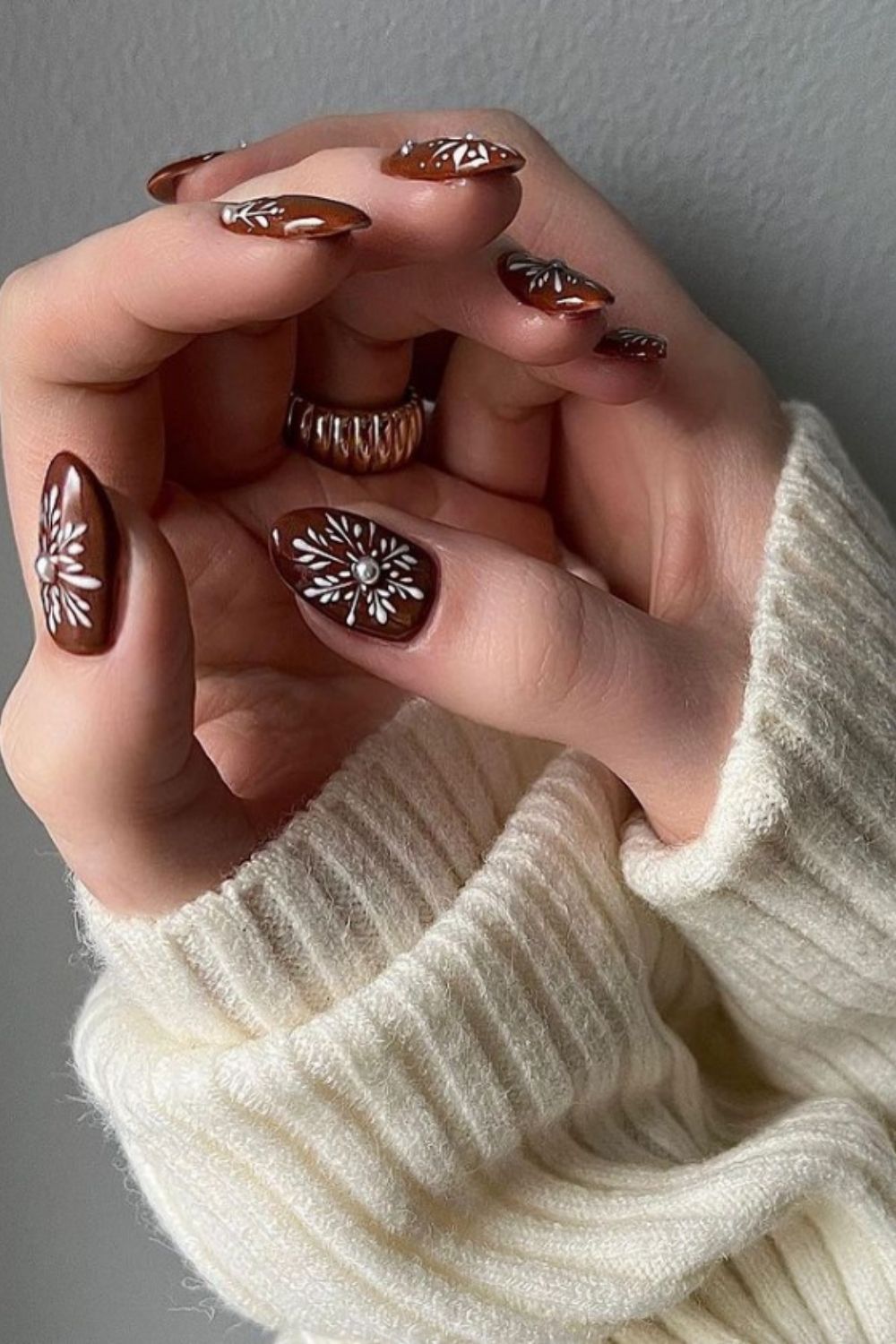 Brown almond nails with snowflake